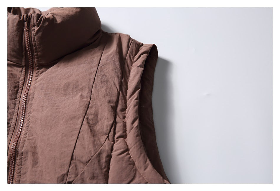 Close-up of the vest's tall collar, zipper, and sleeveless armhole edge.