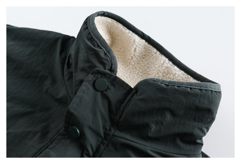 Close-up of a dark jacket collar with cream sherpa lining and two snap buttons.
