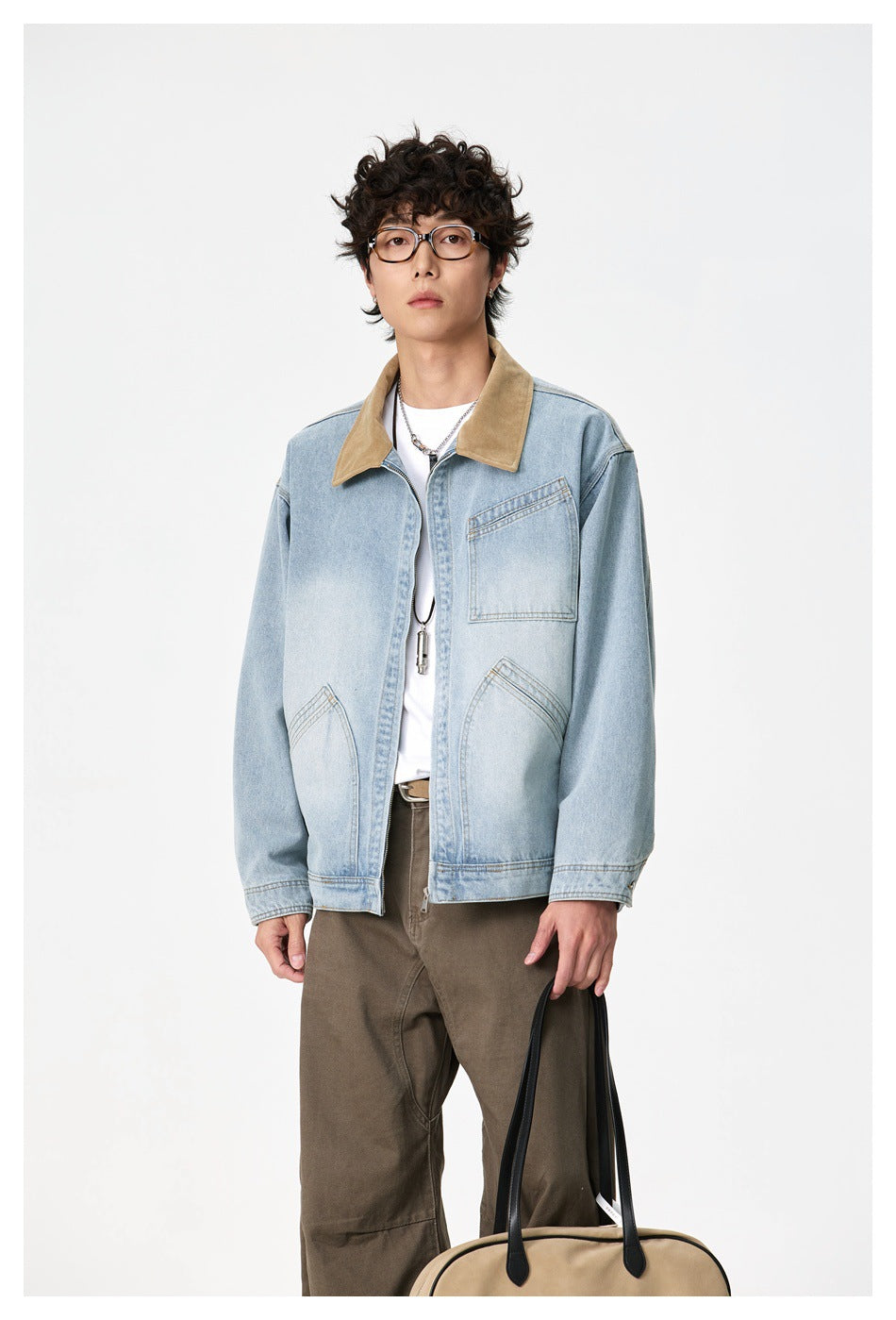 Front view of a model wearing a light-wash denim jacket with a tan collar and two lower pockets.