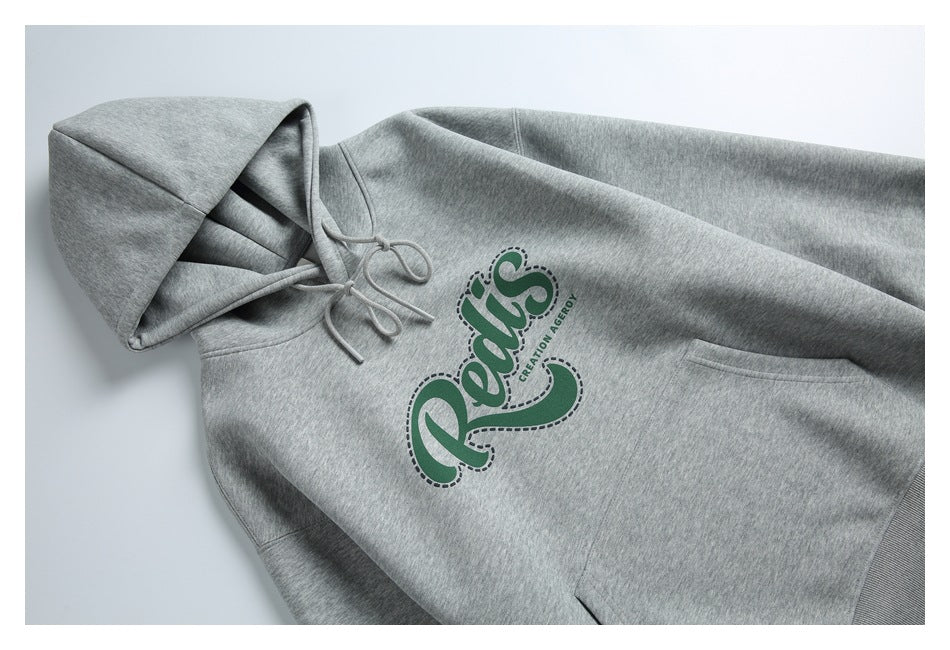 Heather gray pullover hoodie laid flat, with drawstrings, a kangaroo pocket, ribbed hem, and green chest graphic.