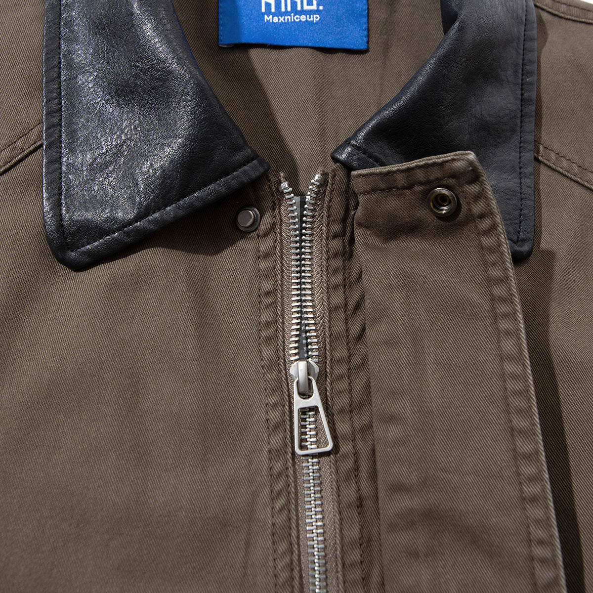 Close-up of the taupe jacket’s black collar and silver front zipper beneath a buttoned placket.