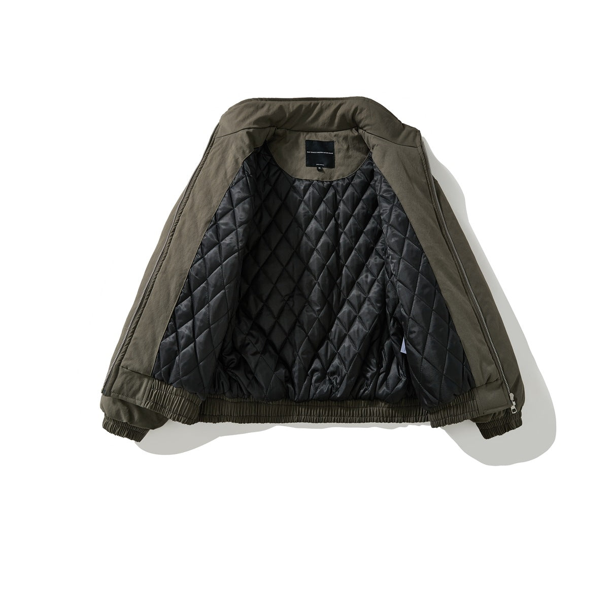 Open dark olive jacket showing its black diamond-quilted lining, elastic hem, and cuffs.