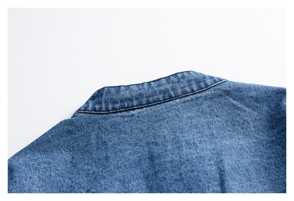 Close-up of the collar seam on a blue denim garment.