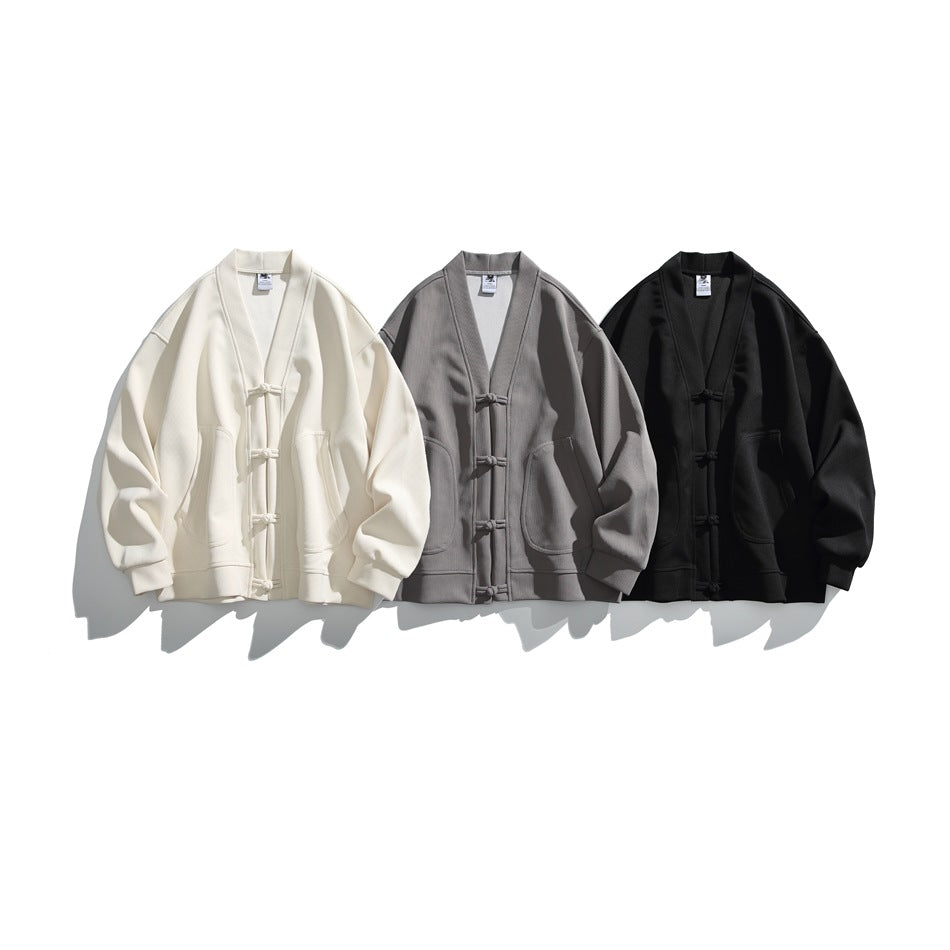 Three frog-button cardigans with front pockets shown together in cream, gray, and black.