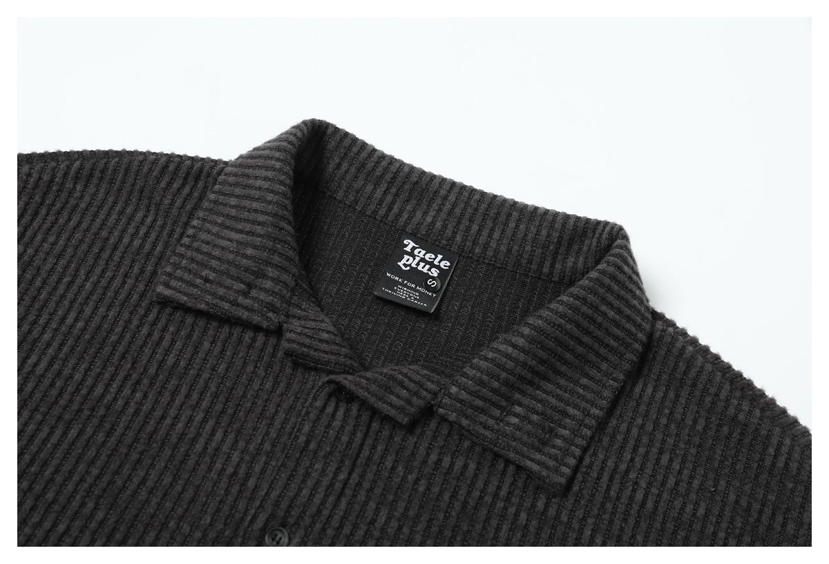 Close-up of a dark charcoal ribbed shirt collar, button, and inner neck label.