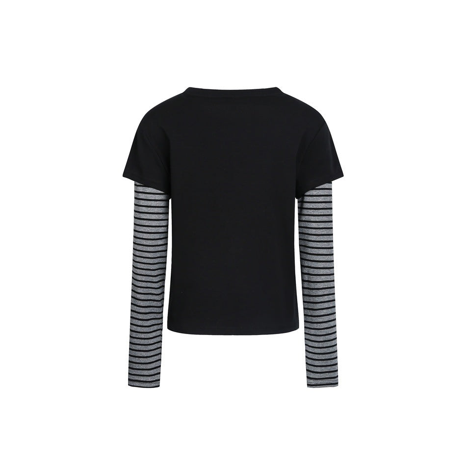 Back view of a black short-sleeve top layered over long gray sleeves with black horizontal stripes.