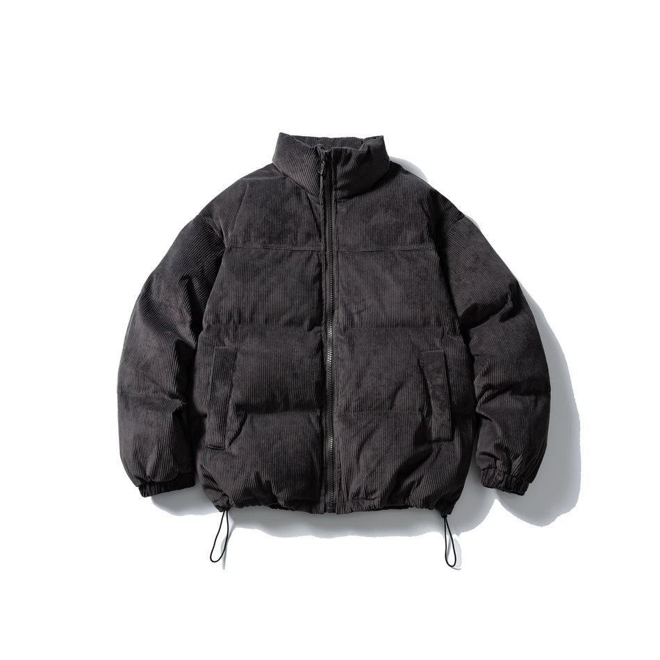 Dark gray corduroy-look puffer jacket with stand collar, front zipper, flap pockets and drawcord hem, flat lay