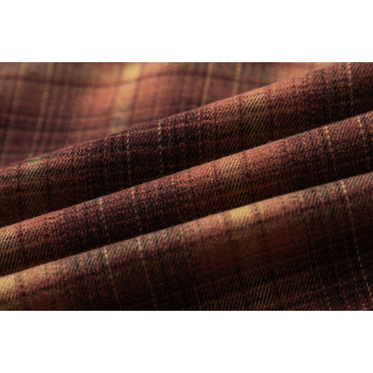 Macro view of the brown, rust, and tan plaid fabric texture.