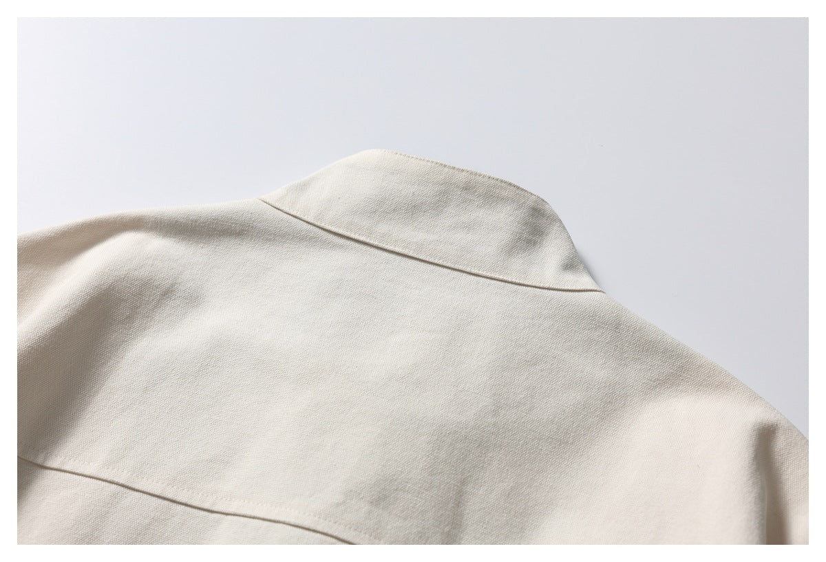 Close-up of the ivory jacket's back collar and horizontal yoke seam.