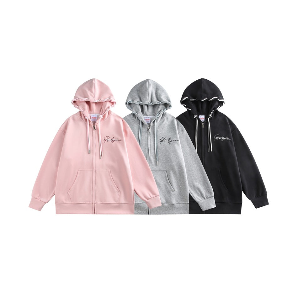Three zip-up hoodies shown together in pink, light gray, and black, each with a hood, drawstrings, and front pockets.