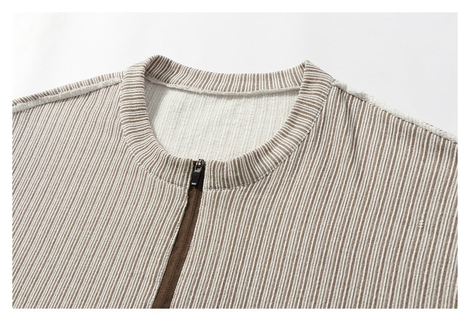 Close-up of a striped garment's ribbed collar and front zipper.