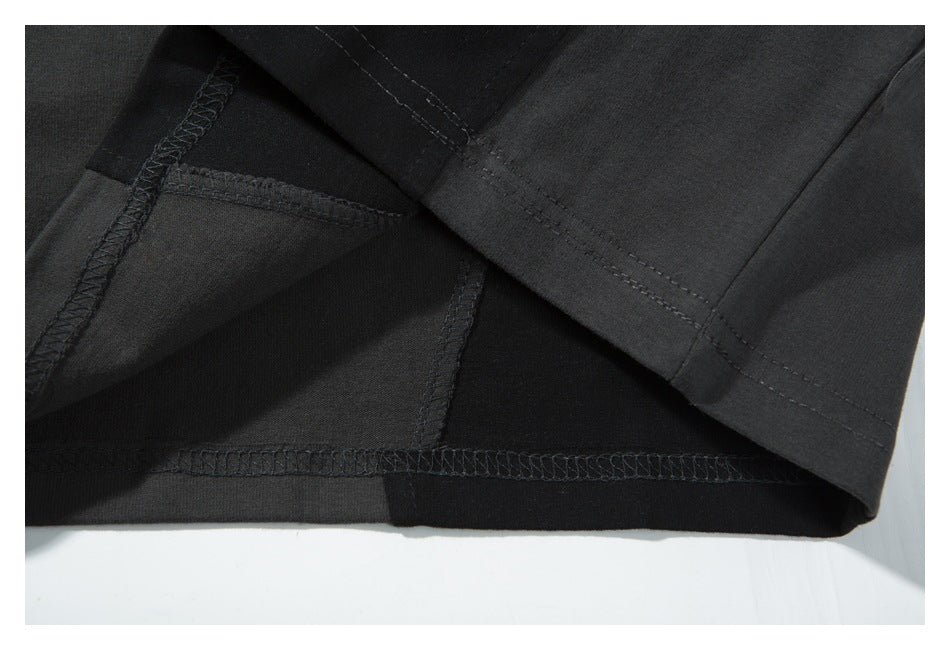 Close-up of the shirt's inside hem, showing dark overlock stitching and a folded edge.