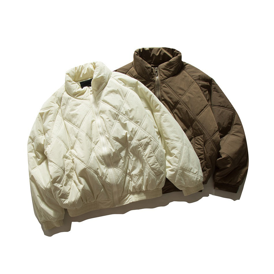 Ivory and dark brown quilted zip-front jackets with stand collars and gathered hems, shown from the front.