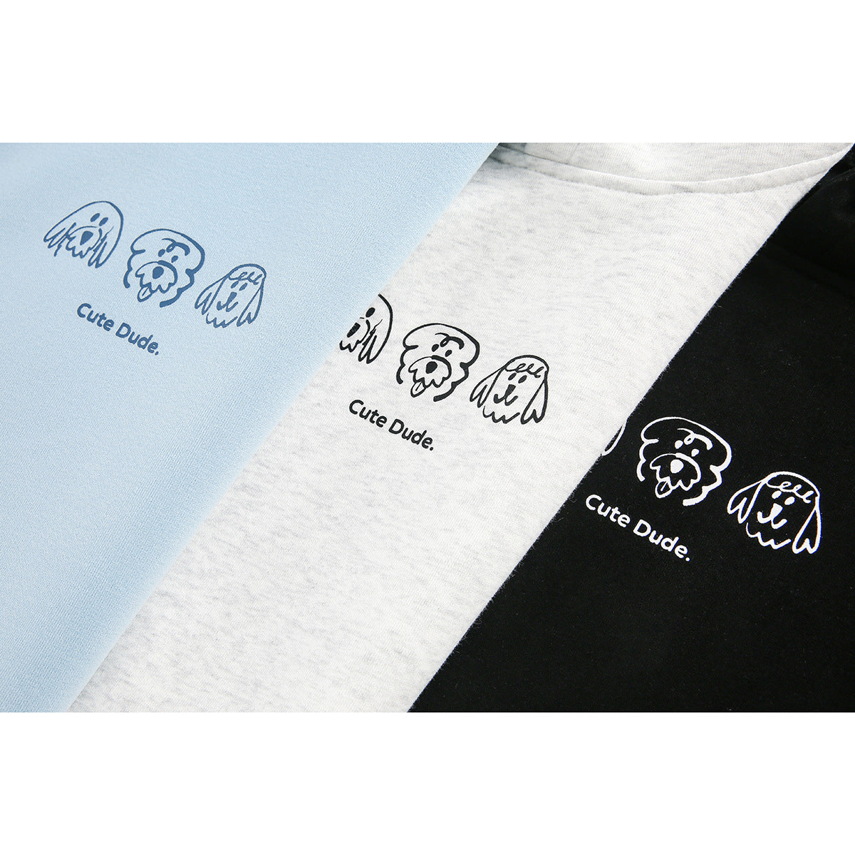 Close-up of hoodie chest prints with ghost-like doodles and “Cute Dude” lettering on blue, heather gray, and black fabric.