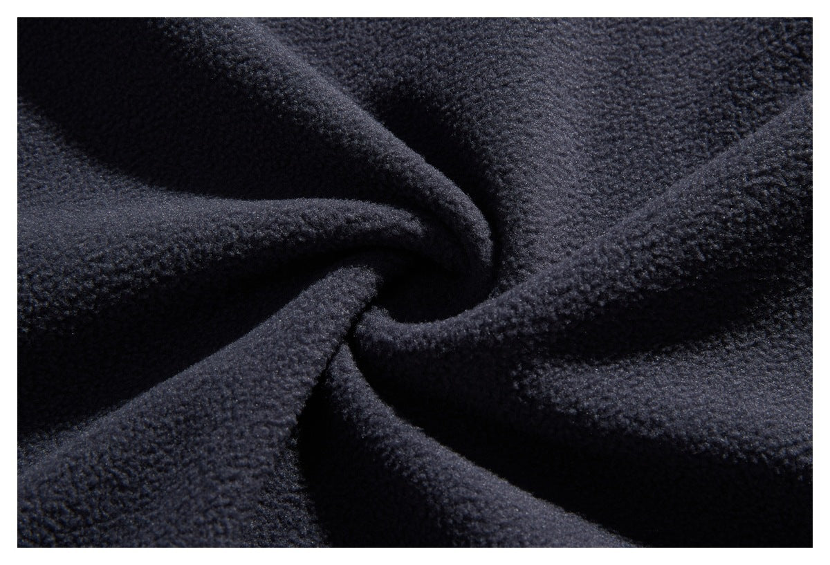 Macro view of the textured dark navy fleece fabric gathered into folds.