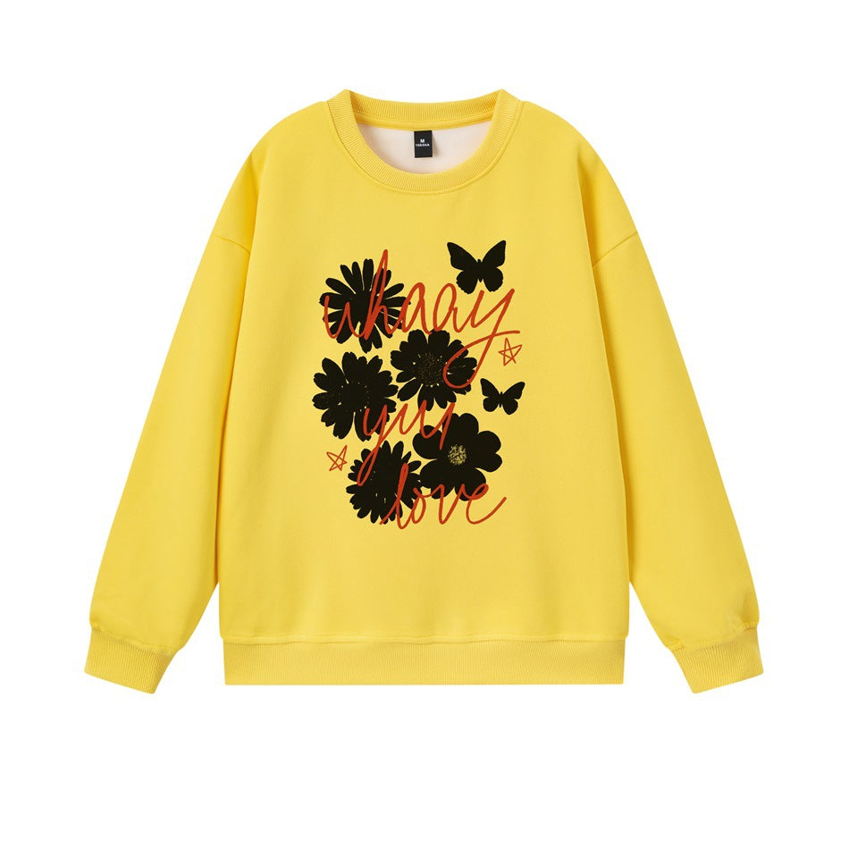 Yellow crewneck sweatshirt with black flower and butterfly print and red script lettering on the front