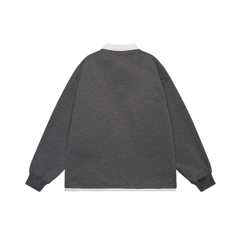 Back view of a dark gray long-sleeve top with a white collar and a white strip visible below the hem.