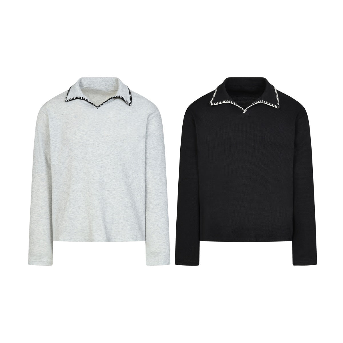 Front view of two long-sleeve tops, one light gray and one black, with contrast blanket stitching on the collars.