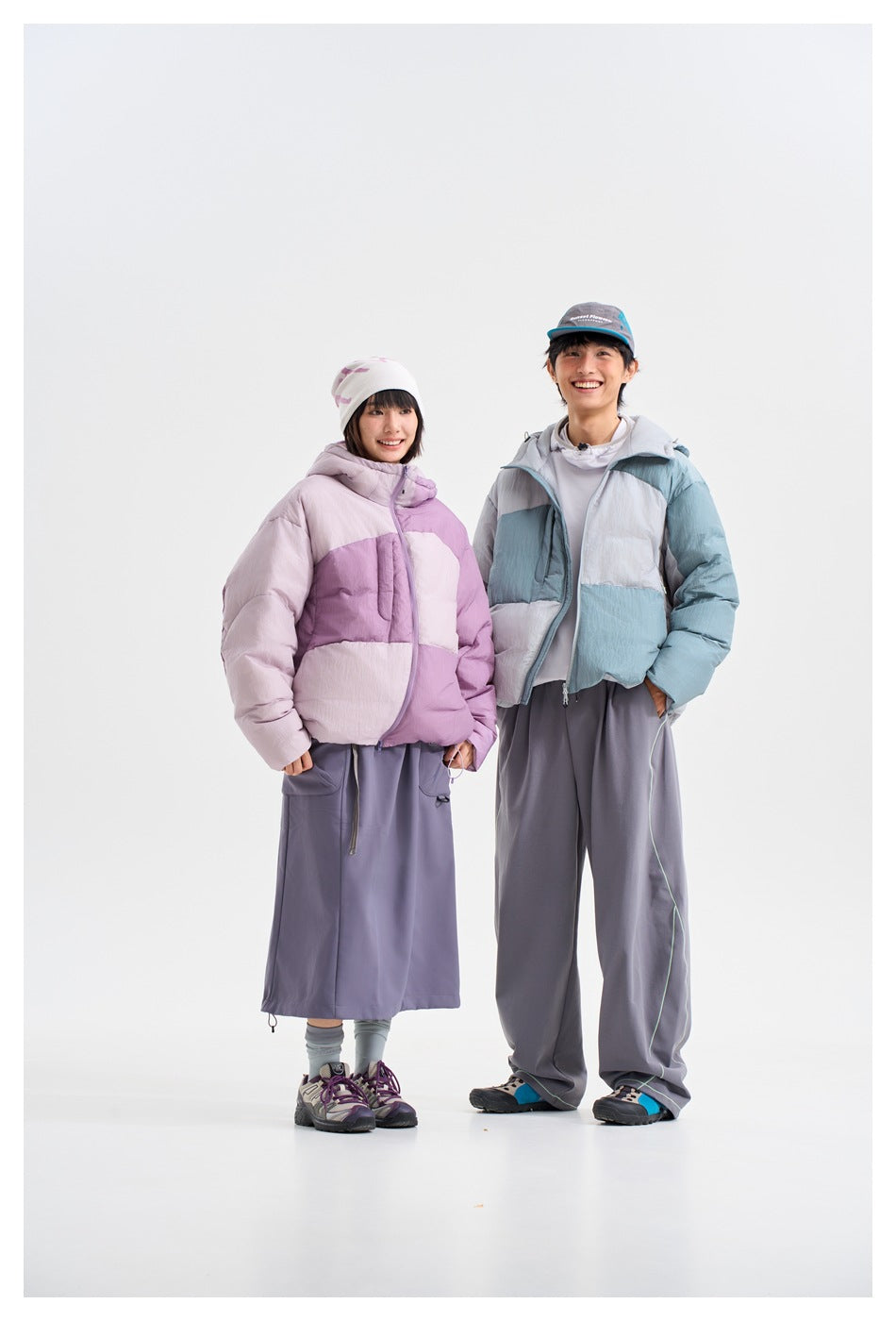 Two models show the puffer jacket in lavender and pale pink, and blue-gray color-block versions.