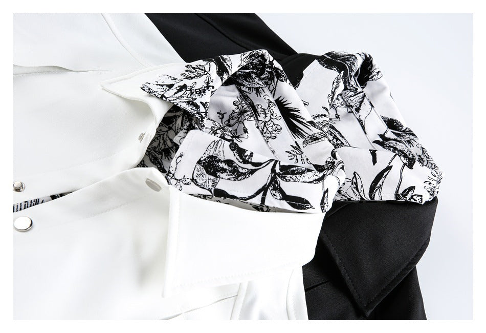 Close-up of black-and-white botanical print beside the white jacket's collar and snap placket.