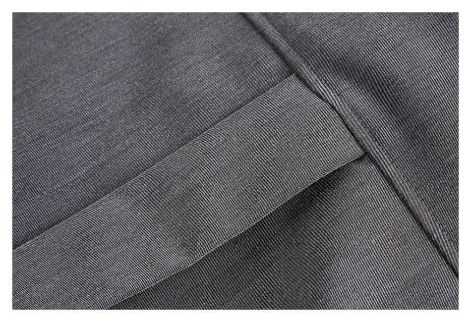 Close-up of a wide charcoal gray fabric panel crossing another panel, with visible seams and stitching.
