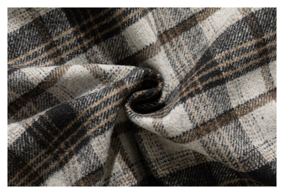 Close-up of the plaid fabric gathered into a fold, showing its fuzzy surface and dark inner side.
