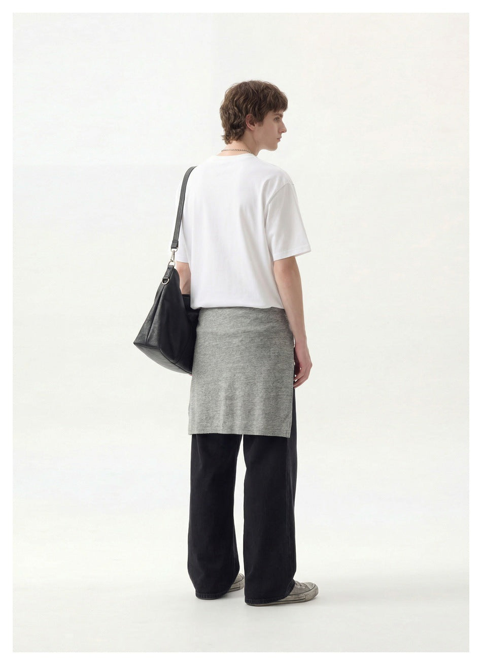 Model viewed from behind wearing a plain white T-shirt with black wide-leg trousers and a gray wrap.