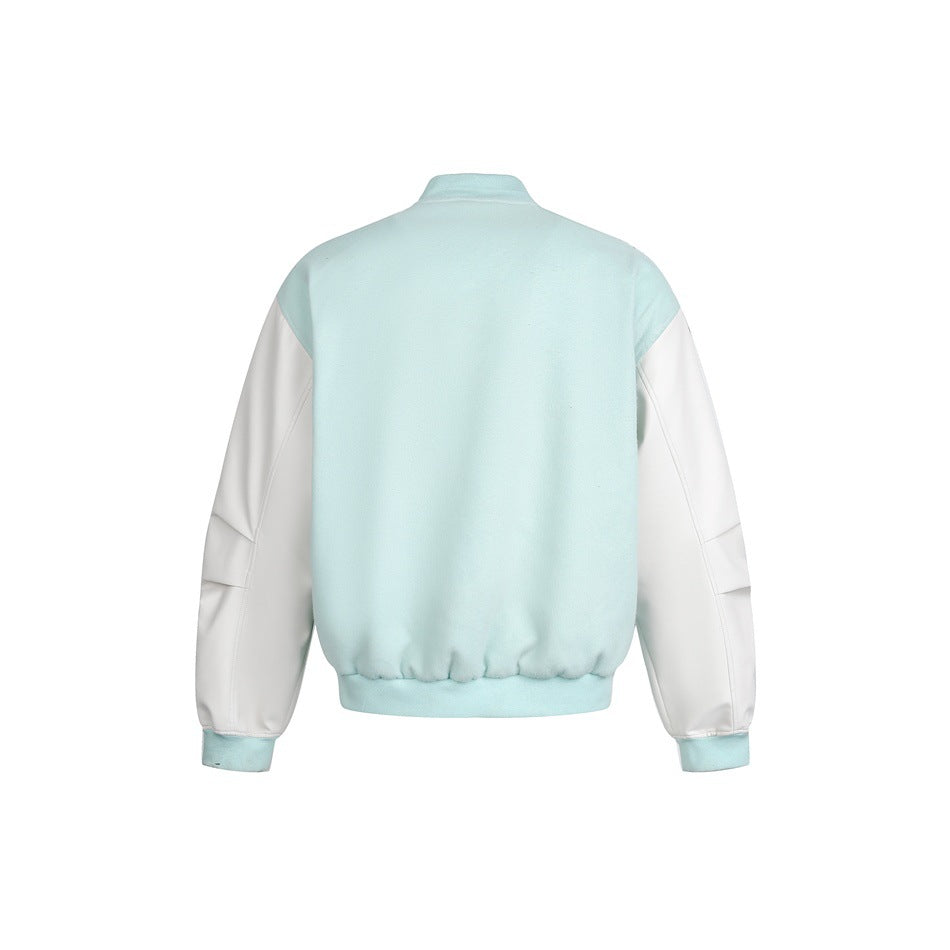 Back view of a pale aqua jacket with white sleeves, a stand collar, and ribbed cuffs and hem.