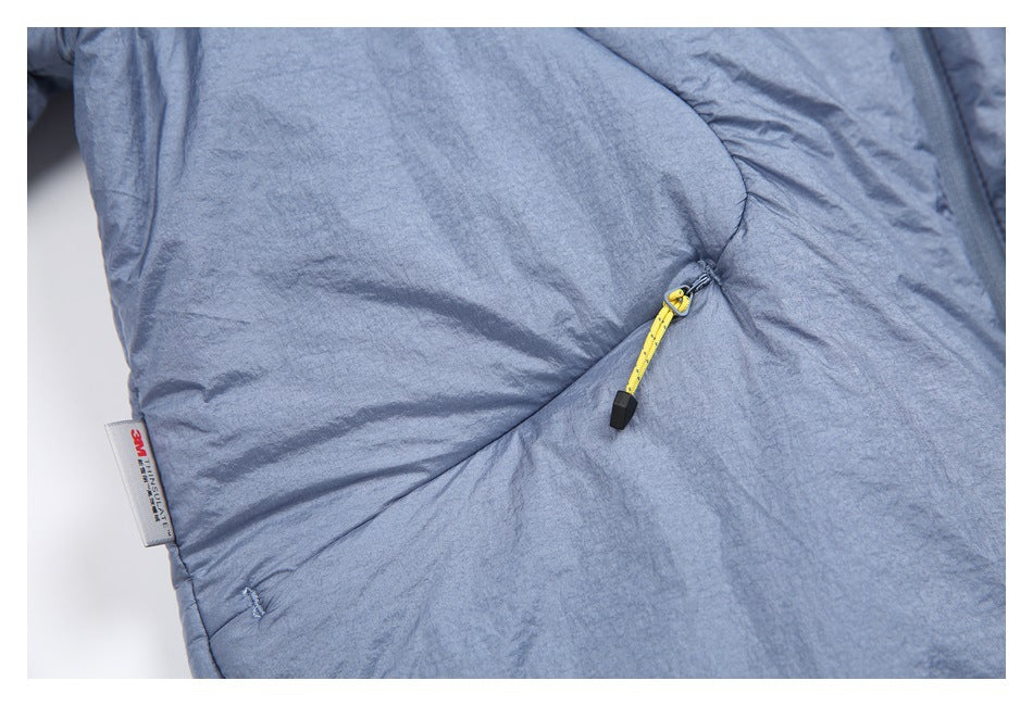Close-up of a yellow cord pocket pull and a small sewn label on the blue-gray jacket.