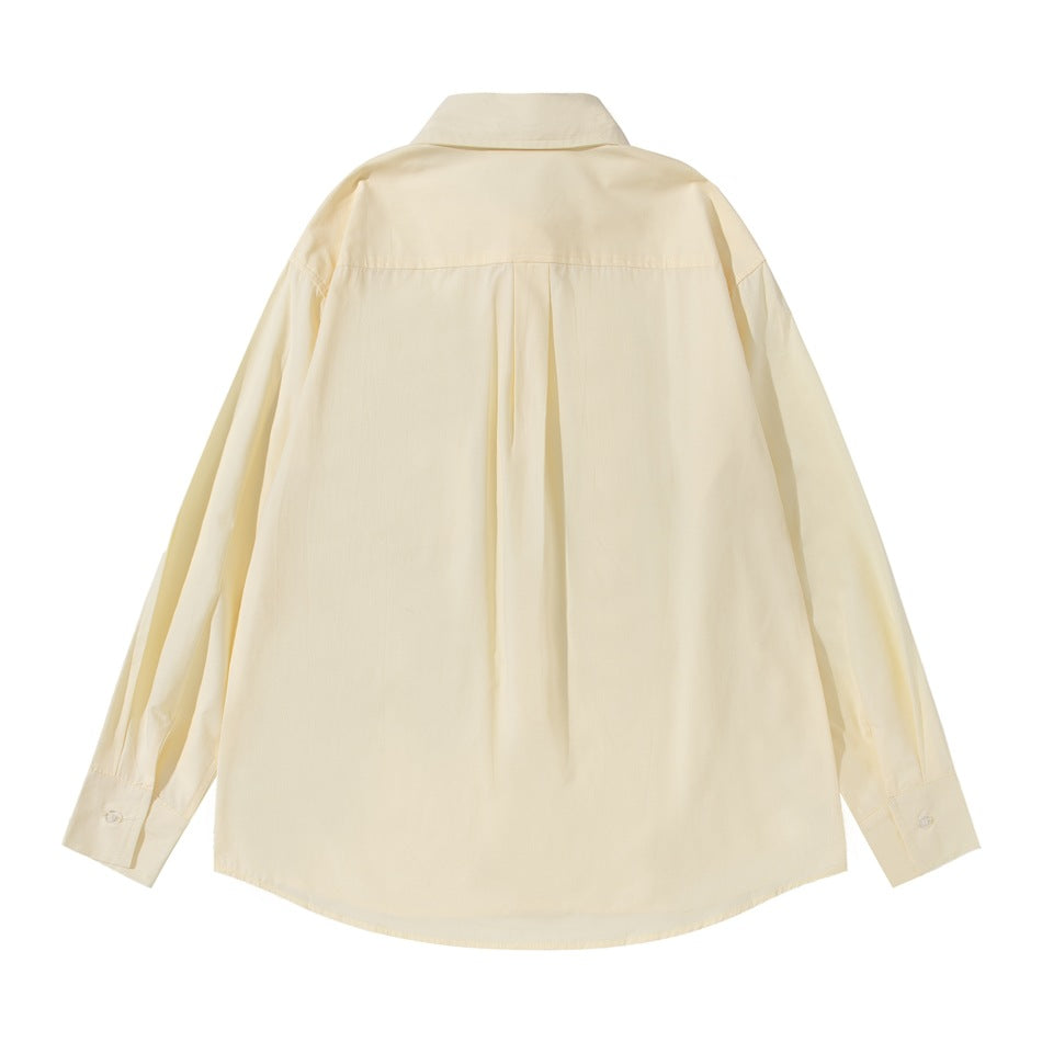 Back view of a pale cream long-sleeve button-up shirt with a pointed collar and center pleat.