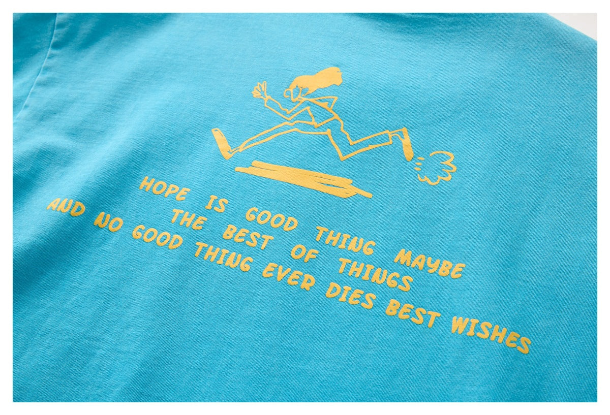 Close-up of a yellow running figure and text printed on the back of a turquoise T-shirt.