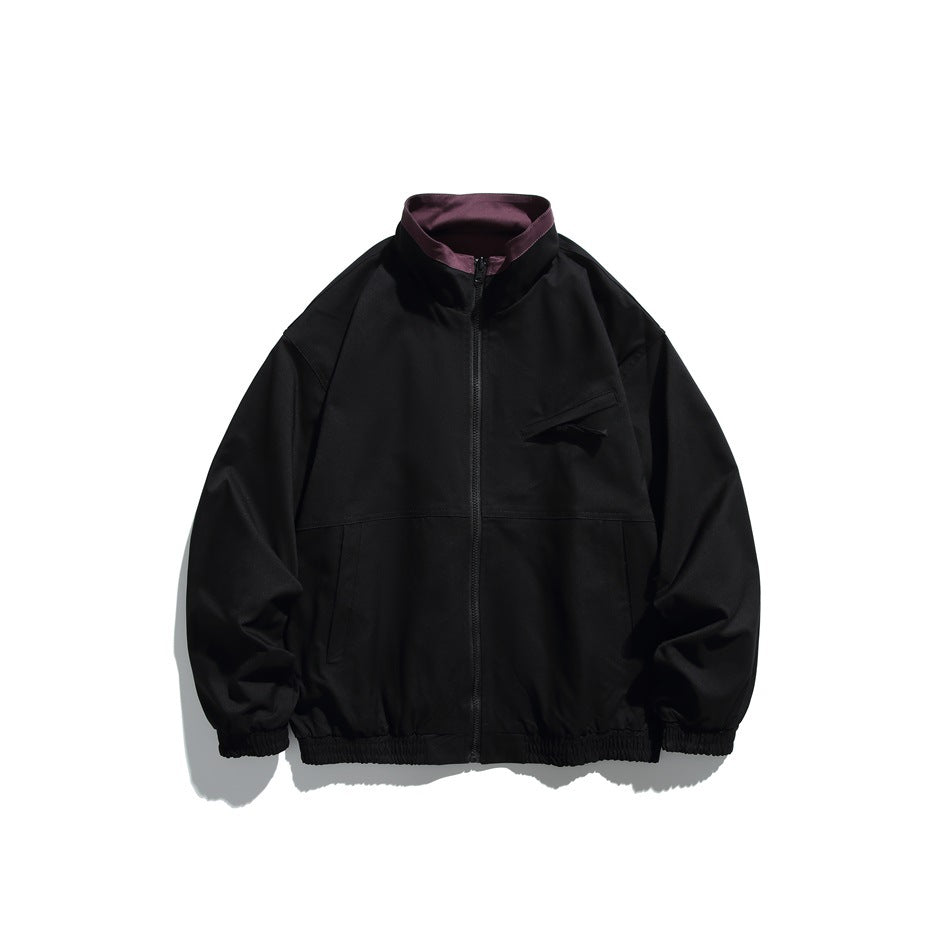 Black stand-collar zip jacket with plum contrast collar lining, chest zip pocket and elastic cuffs and hem, flat front view