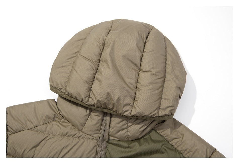 Close-up of the jacket's padded hood, showing its quilted construction and dark olive chest panel.