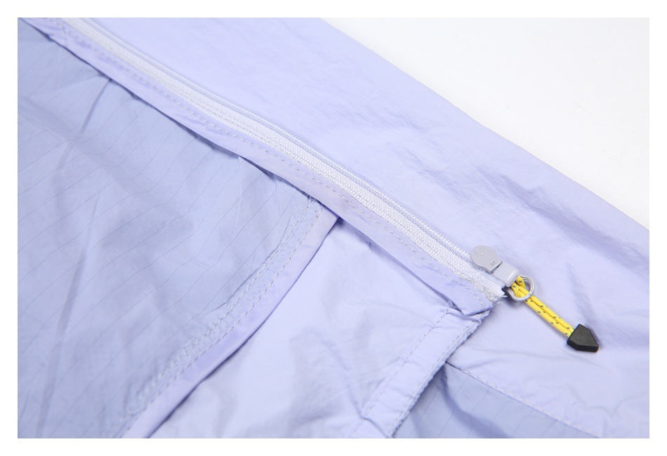 Close-up of a lavender garment's white zipper, yellow pull cord, and stitched seams.