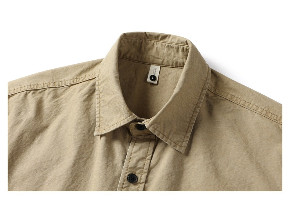 Close-up of the tan shirt's pointed collar, front buttons and inner size tag marked L.
