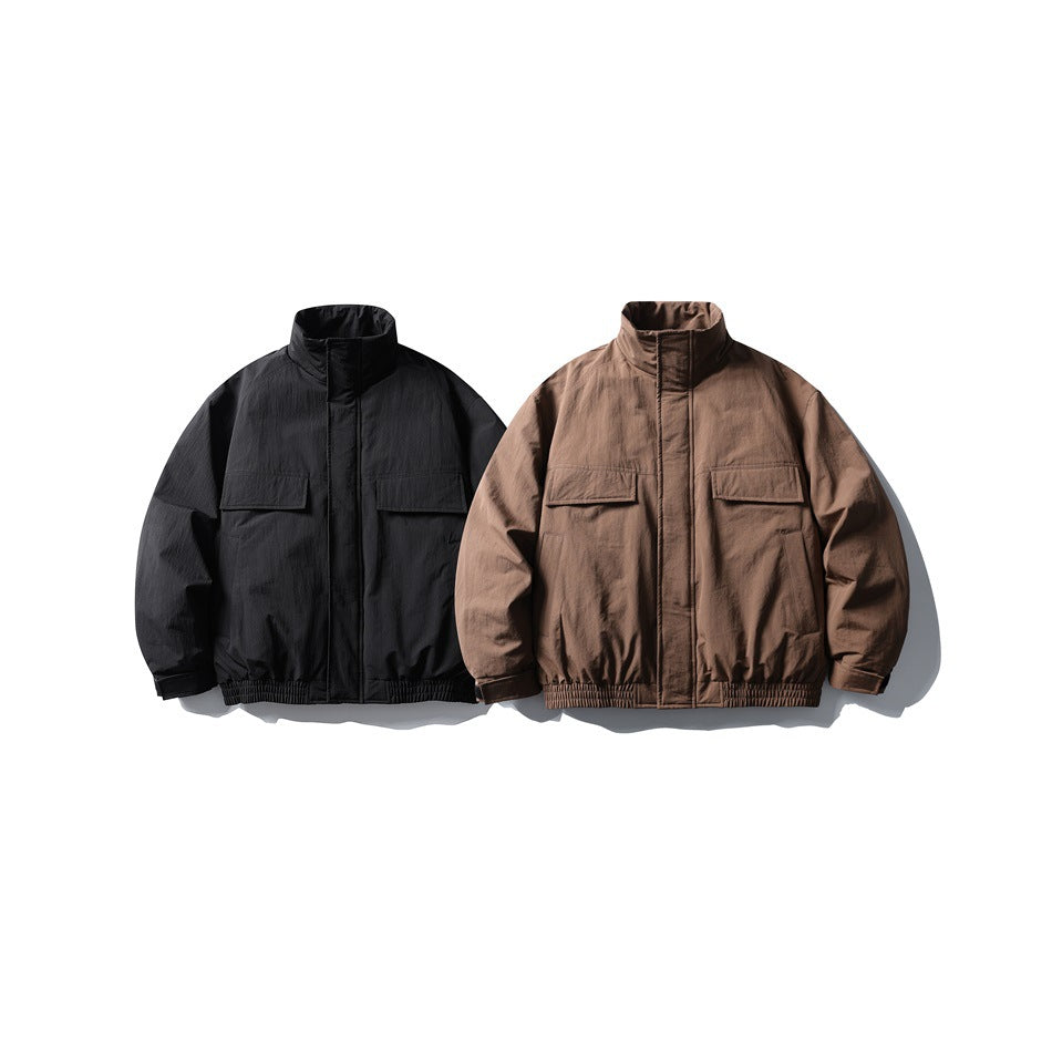 Front view of two jackets with stand collars, flap pockets, and elastic hems: one black and one brown.