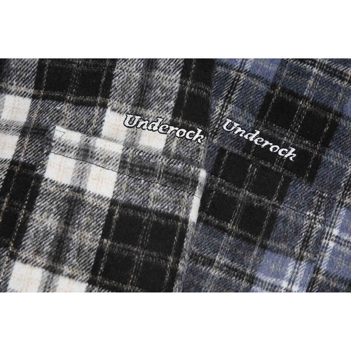 Close-up of white embroidered lettering on black, gray, and blue plaid fabric.