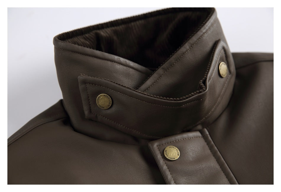 Close-up of the dark brown jacket’s high collar and snap-button closure with brass-tone hardware.
