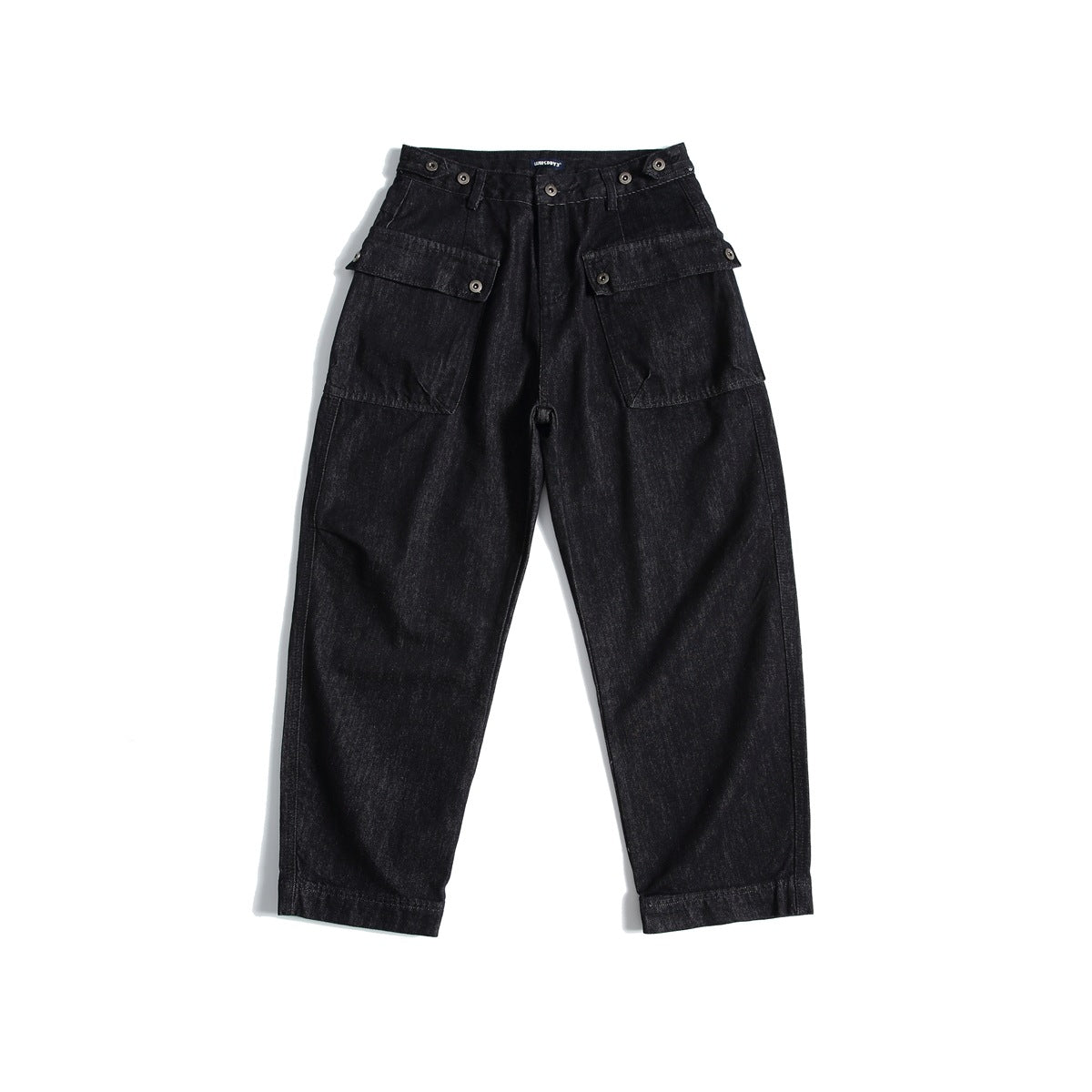 Front view of black-blue washed denim jeans with large flap pockets, button waist tabs and a relaxed tapered leg