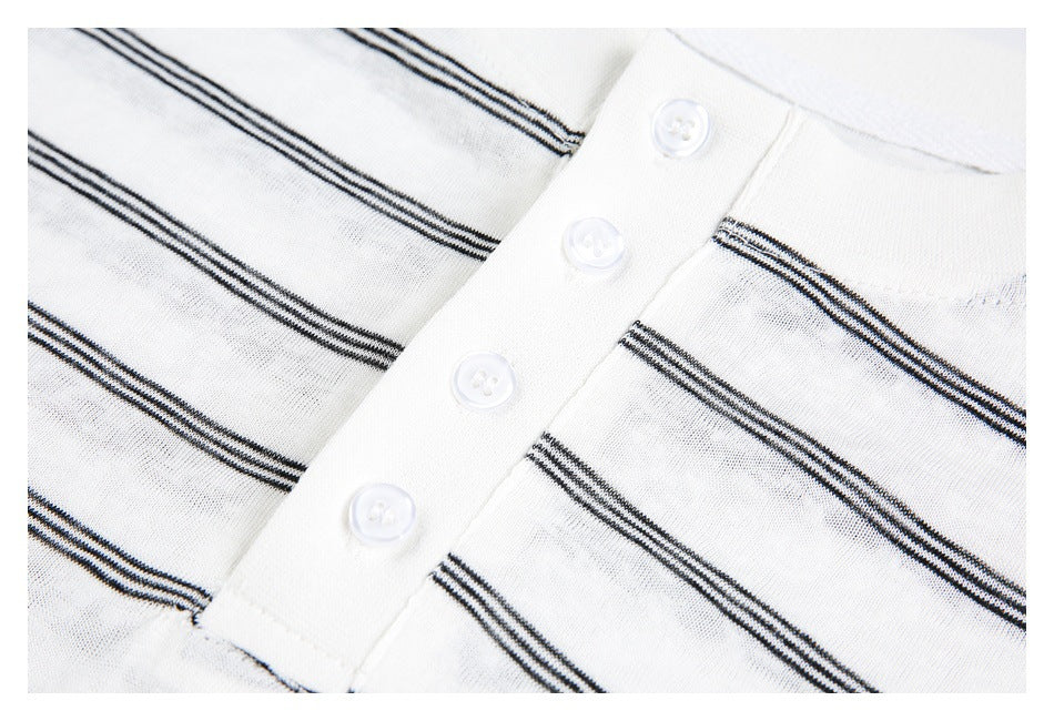 Close-up of the four-button placket and dark horizontal stripes on a white shirt.