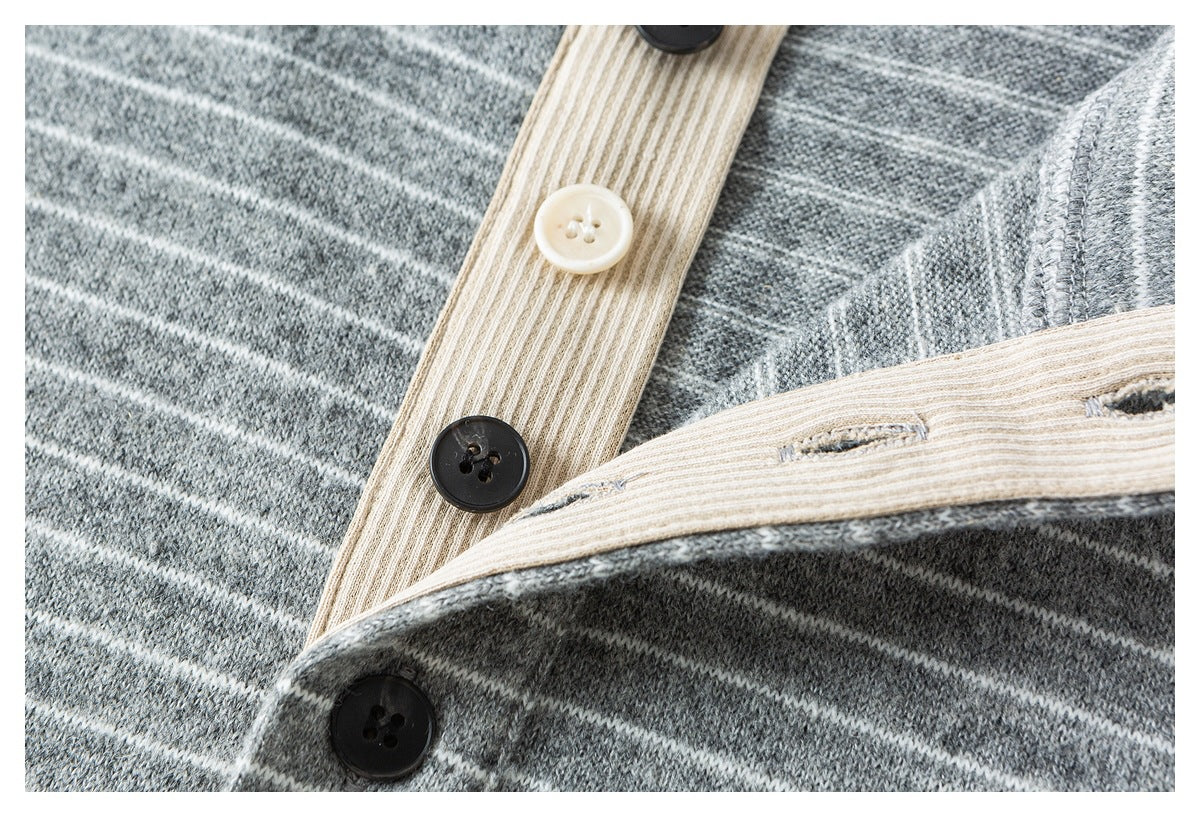 Close-up of the striped shirt's button placket and beige inner facing with dark and cream buttons.