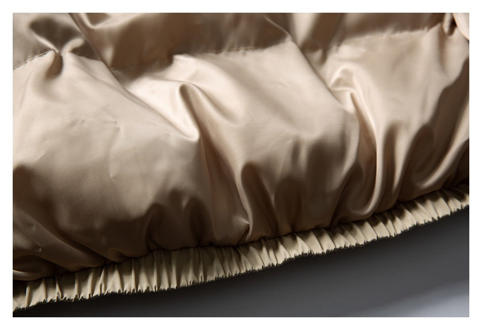 Close-up of the beige jacket's gathered elastic hem and inner fabric.