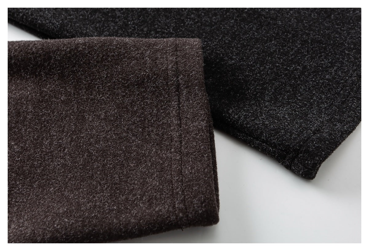 Close-up of the dark brown jacket's sleeve cuff and textured fabric.