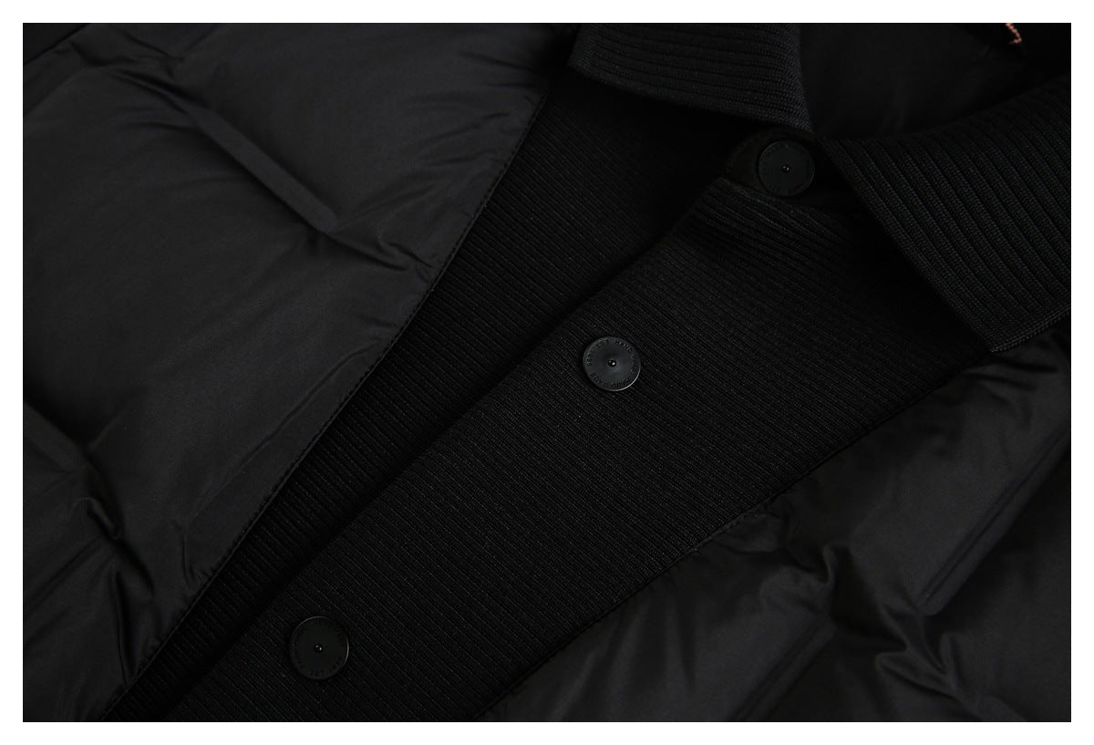 Close-up of a black jacket's ribbed front placket with buttons and quilted panels.