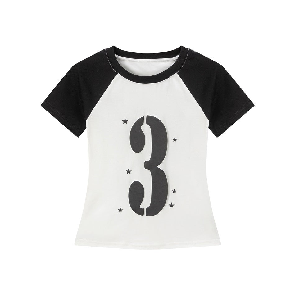 White raglan T-shirt with black sleeves and collar, large stencil number 3 graphic and small stars, flat lay