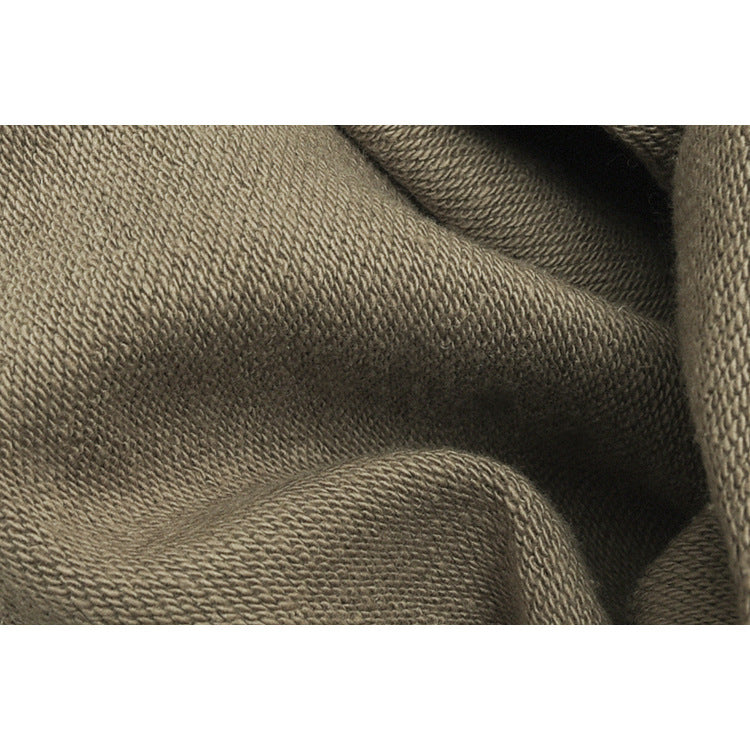 Close-up of the taupe fabric's textured knit surface.