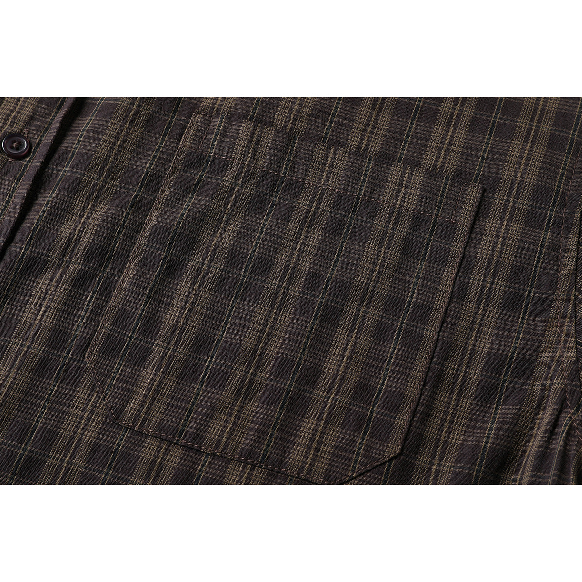 Close-up of a dark brown plaid shirt's button-front chest pocket.
