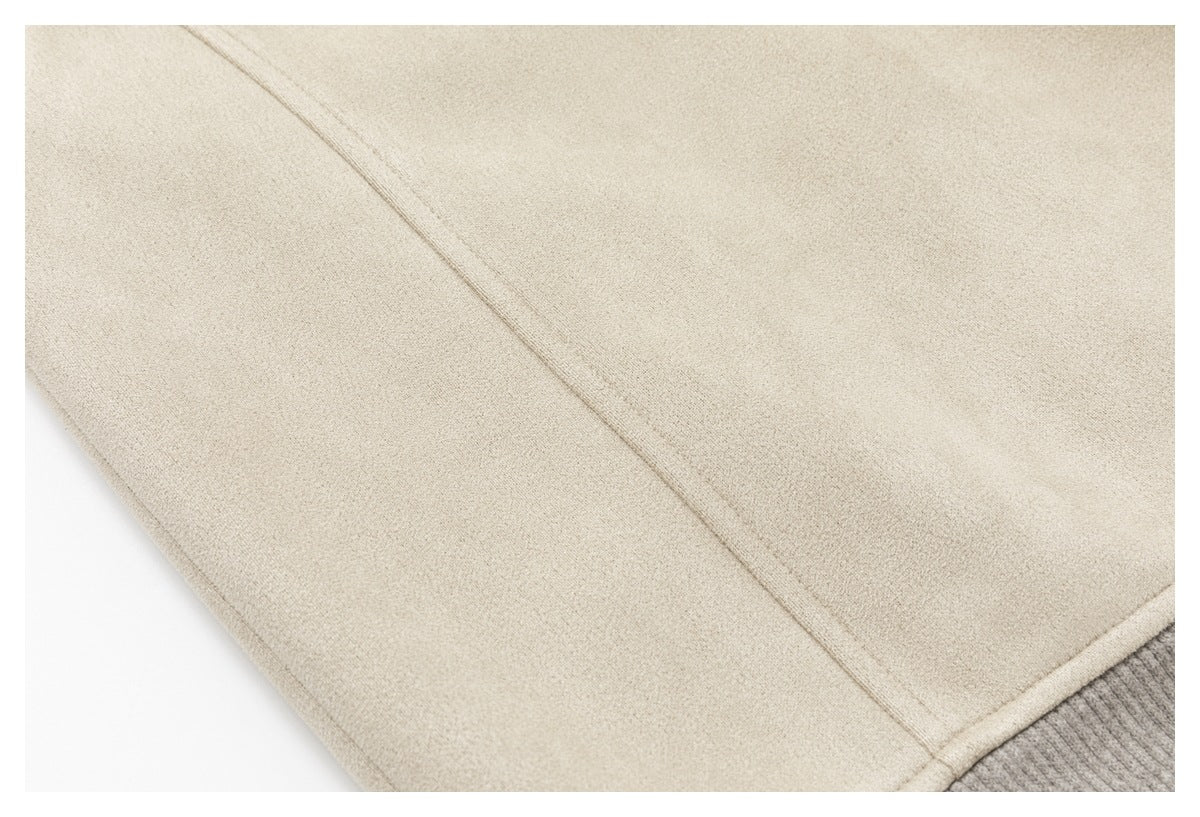 Close-up of cream jacket fabric and a seam, with a gray ribbed edge at the corner.