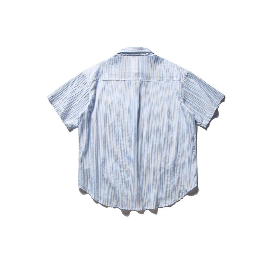 Back view of a blue and white striped short-sleeve shirt laid flat, showing back yoke and curved hem