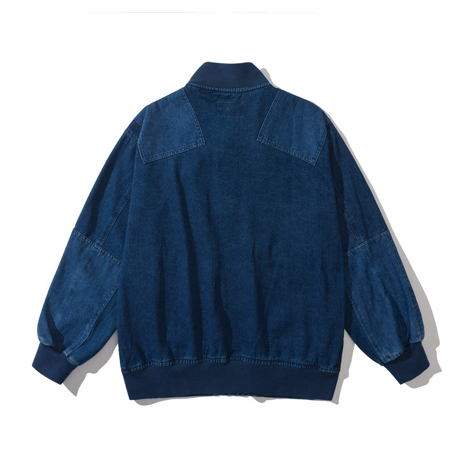 Back of a blue denim bomber-style jacket with shoulder yokes, paneled sleeves and ribbed collar, cuffs and hem